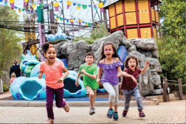 Kids running in front of Land of the Dragons